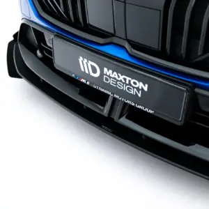 Front of a dark car showing a glossy grille and a Maxton Design license plate area with blue accent lighting.