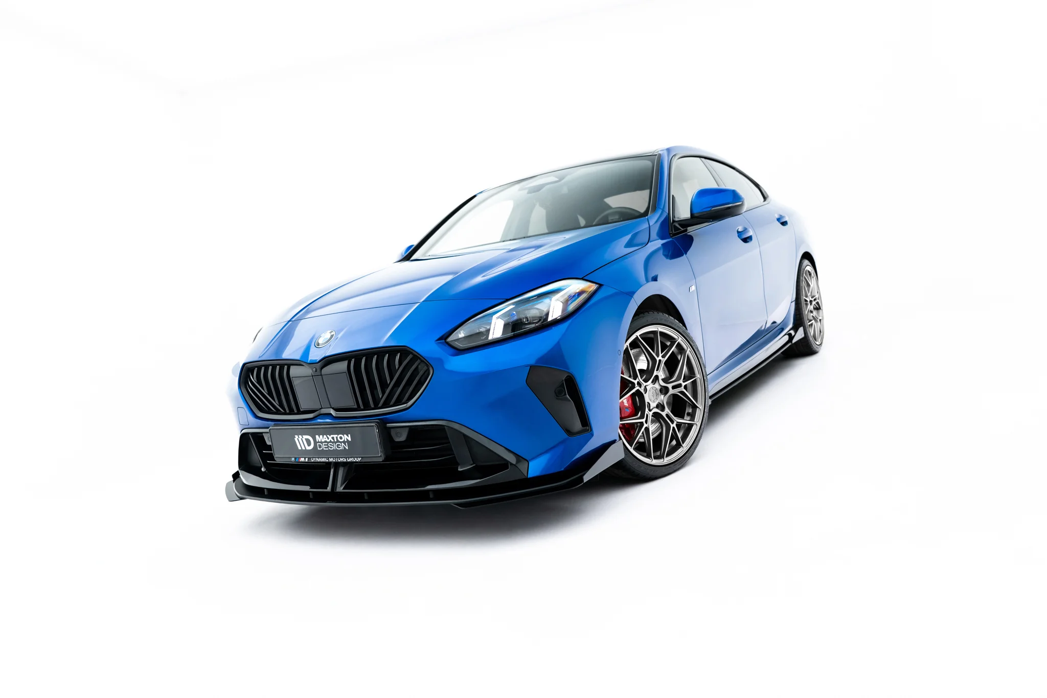 pol_po_Street-Pro-Front-Splitter-Flaps-BMW-2-M-Pack-M235i-Gran-Coupe-F74-23838_2webp - OPSHOLDERS Blue sports car photographed from a low front-left angle on a white background, showing aggressive front grille and detailed alloy wheels.