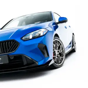 Blue BMW car shown from a low front-left angle, highlighting the grille, headlight, and alloy wheel.