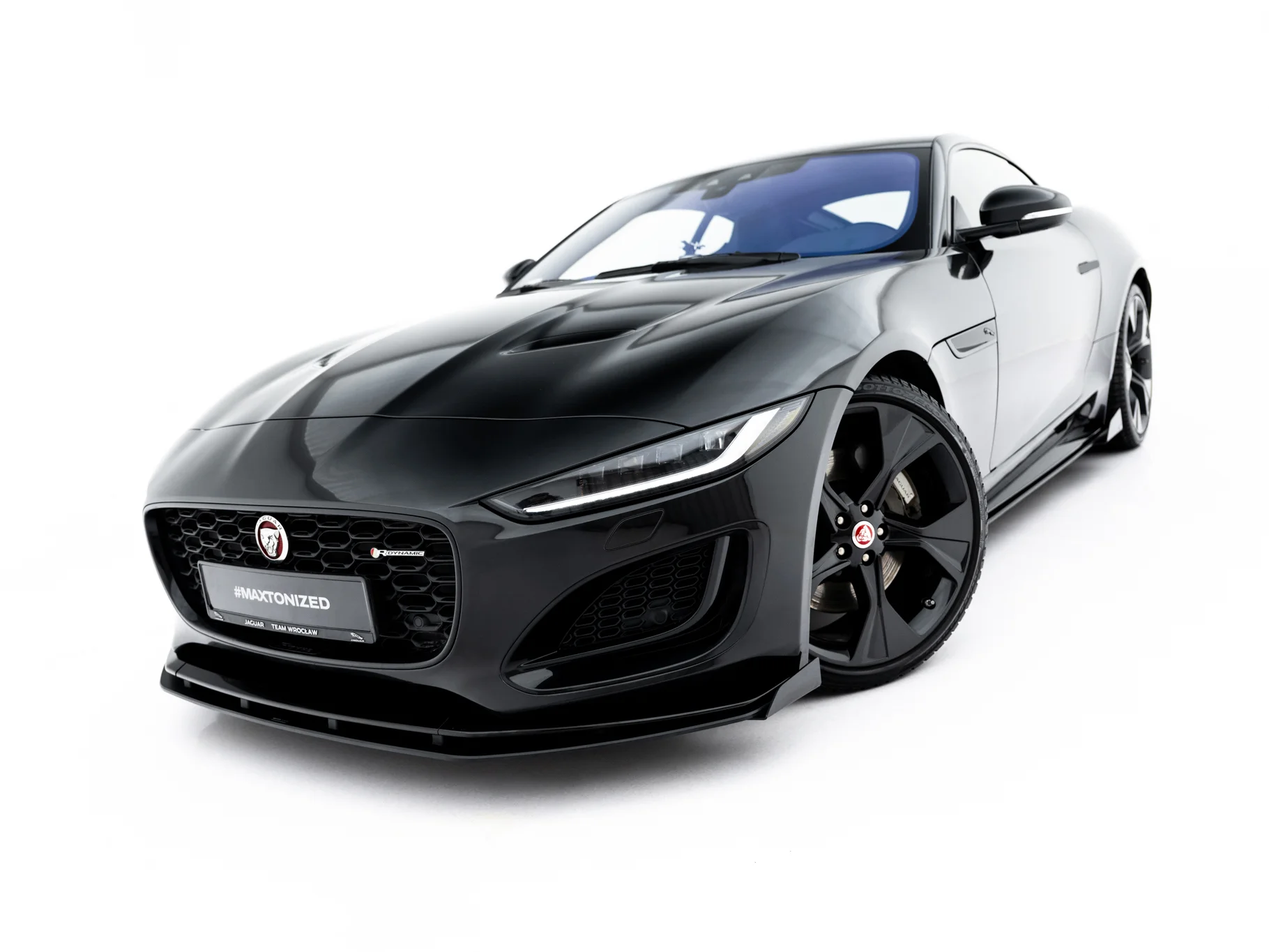 pol_po_Street-Pro-Front-Splitter-Flaps-Jaguar-F-Type-X152-Facelift-2-23974_8webp - OPSHOLDERS Black Jaguar sports car photographed from a low front-left angle, showing sleek hood and grille with Jaguar emblem
