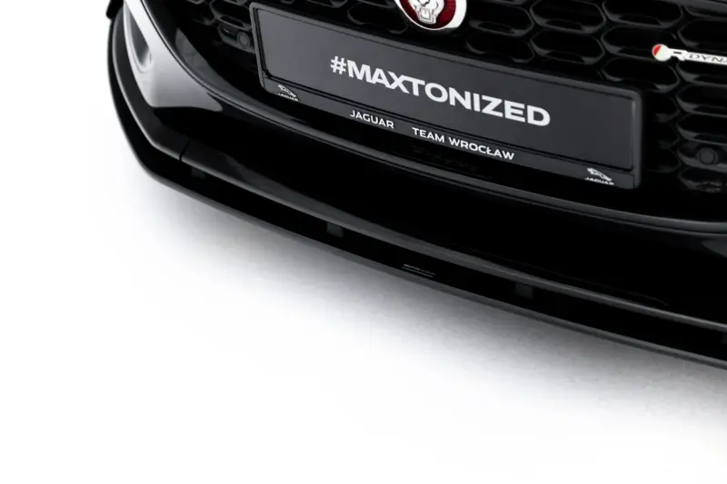 pol_po_Street-Pro-Front-Splitter-Flaps-Jaguar-F-Type-X152-Facelift-2-23975_1webp - OPSHOLDERS Close-up of a black Jaguar car front with a plate that reads #MAXTONIZED and small Jaguar branding below it.