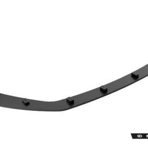 Curved dark gray car aero lip with multiple mounting tabs, likely a front splitter or side skirt edge piece, shown in isolation.
