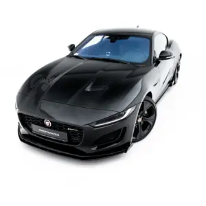 Top-front angled view of a sleek black Jaguar sports car with glossy hood and blue-tinted windshield on a white background.