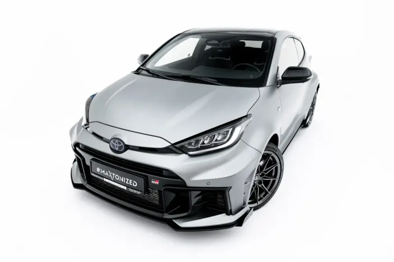 Front-left angled view of a silver car showing its sporty grille, headlights, and alloy wheels.