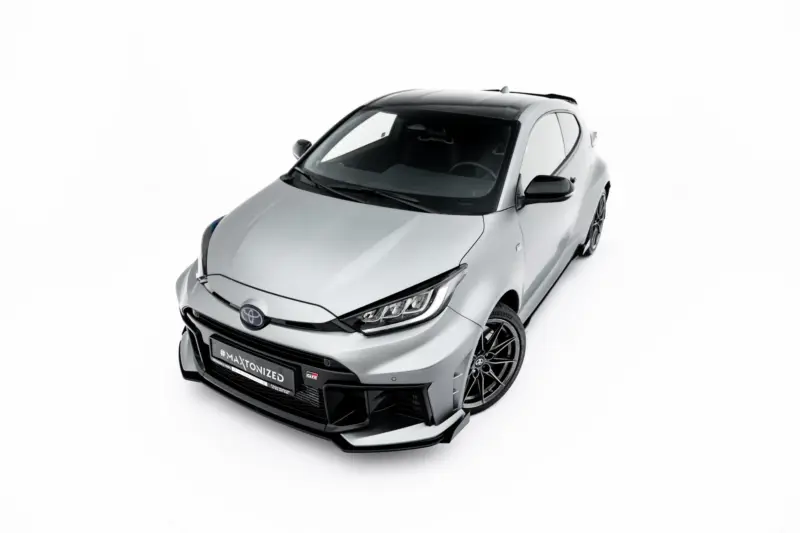 Silver sports car photographed from a high front-left angle, showing a black roof, aggressive front bumper and alloy wheels (Toyota badge visible).