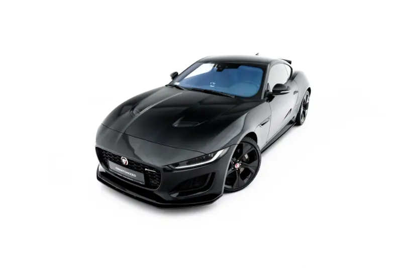 Black Jaguar sports car photographed from the front-left angle against a white background, highlighting its glossy finish and low stance.