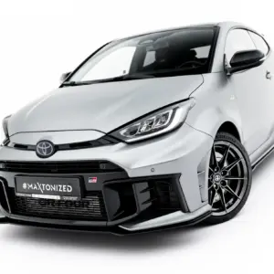 Front three-quarter view of a silver Toyota GR sports hatch with a wide body kit, large alloy wheels, and a prominent #MAXTONIZED plate.