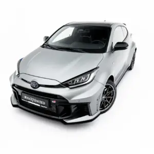 Front three-quarter view of a white sports hatchback with a black roof and large alloy wheels, featuring #MAXTONIZED on the bumper plate area.