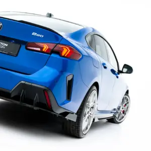 Blue BMW 220 rear view in a studio setting, showing the taillights and Maxton Design plate on a glossy blue trunk.