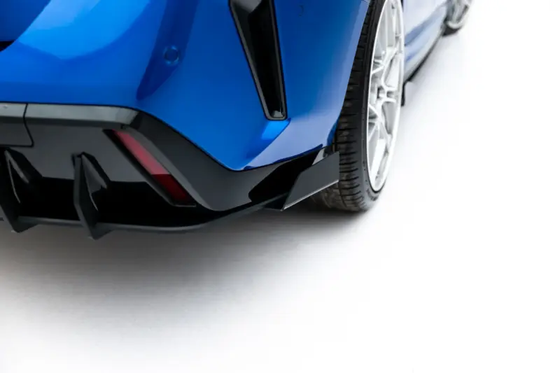 pol_po_Street-Pro-Rear-Diffuser-Flaps-BMW-2-M-Pack-Gran-Coupe-F74-23850_6webp - OPSHOLDERS Close-up of a blue sports car's front bumper and tire, highlighting the aero lip and splitter