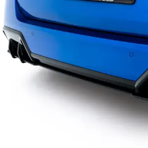 Close-up of the blue car's rear bumper and exhaust diffuser with clean white background.