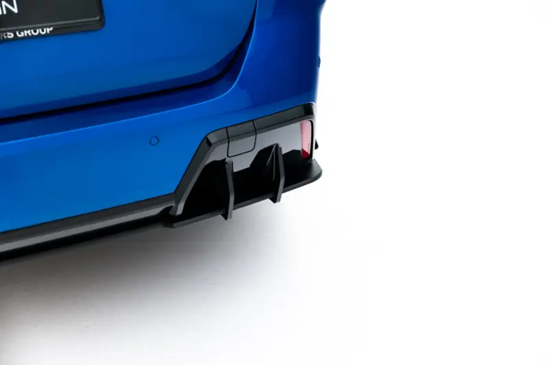 pol_po_Street-Pro-Rear-Diffuser-Flaps-BMW-2-M-Pack-Gran-Coupe-F74-23851_7webp - OPSHOLDERS Close-up of a blue car's rear end, showing the bumper, tail light, and a partial license plate against a white background.