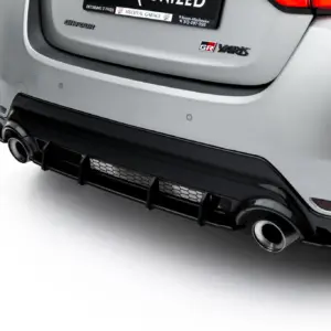 Close-up of the rear bumper of a silver car, showing exhaust pipes and bumper details.