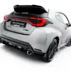 pol_po_Street-Pro-Rear-Diffuser-Toyota-GR-Yaris-Mk4-Facelift-23787_5webp - OPSHOLDERS Rear view of a white performance hatchback with a black roof spoiler and a striking red taillight arc