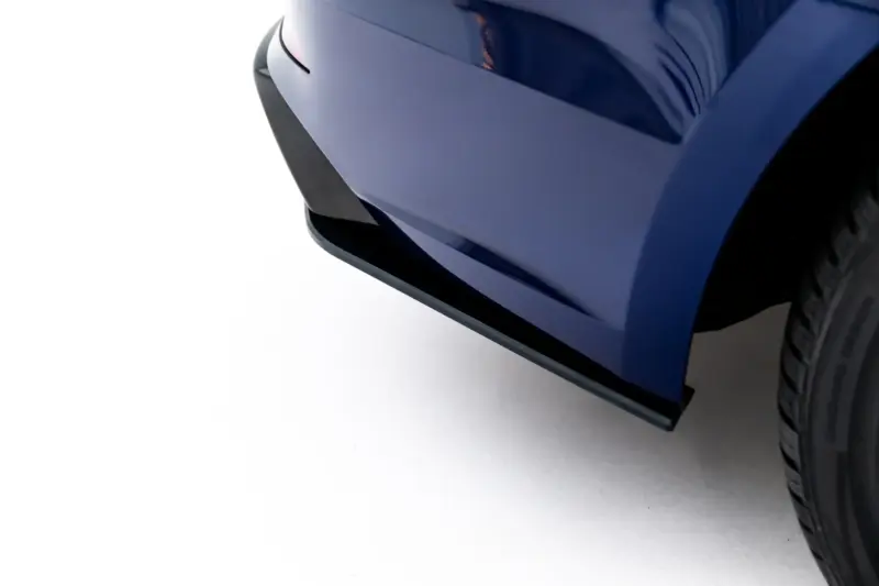 pol_po_Street-Pro-Rear-Side-Splitters-Audi-S5-Coupe-F5-24005_4webp - OPSHOLDERS Close-up of a blue car's front bumper and tire, showing glossy painted surfaces and reflections.