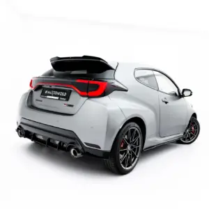 Rear three-quarter view of a silver sports hatchback with a black spoiler, red taillights, large wheels, and a license plate reading #MAJTONIZED against a white studio background
