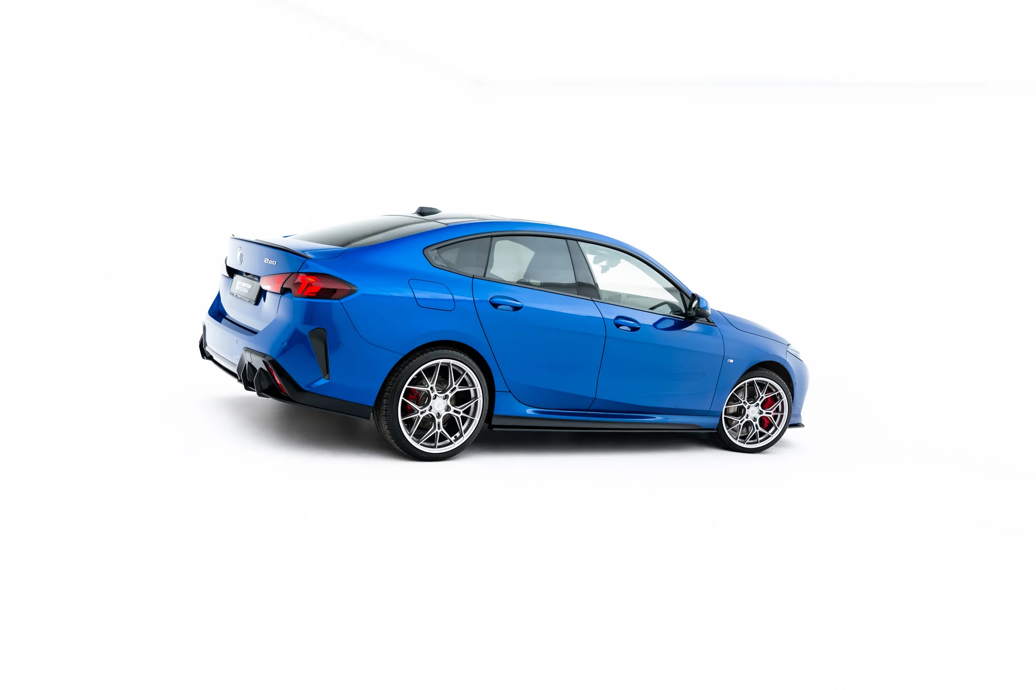 pol_po_Street-Pro-Side-Skirts-Diffusers-BMW-2-M-Pack-M235i-Gran-Coupe-F74-23841_2webp - OPSHOLDERS Blue BMW coupe in a rear three-quarter view with large alloy wheels on a white studio background, highlighting its sporty design.