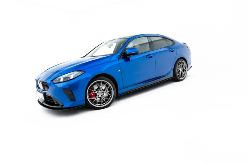 pol_po_Street-Pro-Side-Skirts-Diffusers-BMW-2-M-Pack-M235i-Gran-Coupe-F74-23841_4webp - OPSHOLDERS Blue sporty car photographed from a low front-left angle, showing large multi‑spoke wheels and red brake calipers against a white background.
