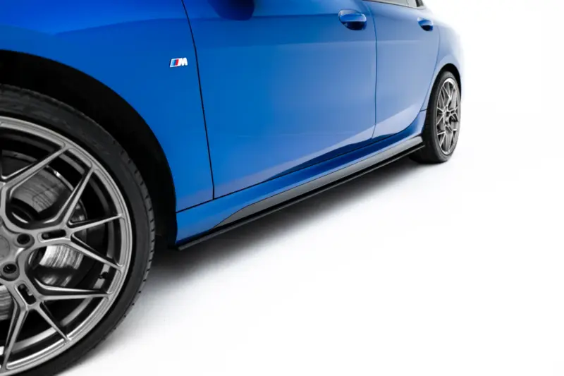 pol_po_Street-Pro-Side-Skirts-Diffusers-BMW-2-M-Pack-M235i-Gran-Coupe-F74-23841_5webp - OPSHOLDERS Close-up of a blue car’s side panel showing the M badge and a large alloy wheel with glossy paint finish