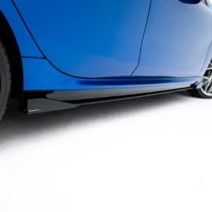 Close-up of a blue sports car's side with a prominent alloy wheel and brake calipers visible at the rear.