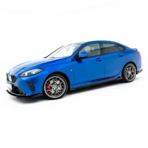 Blue BMW sports car photographed from a front-left angle against a white studio background, showing aggressive front bumper and alloy wheels.