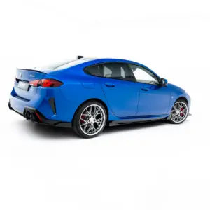 Blue BMW sports sedan shown from rear three-quarter view against a white studio background.