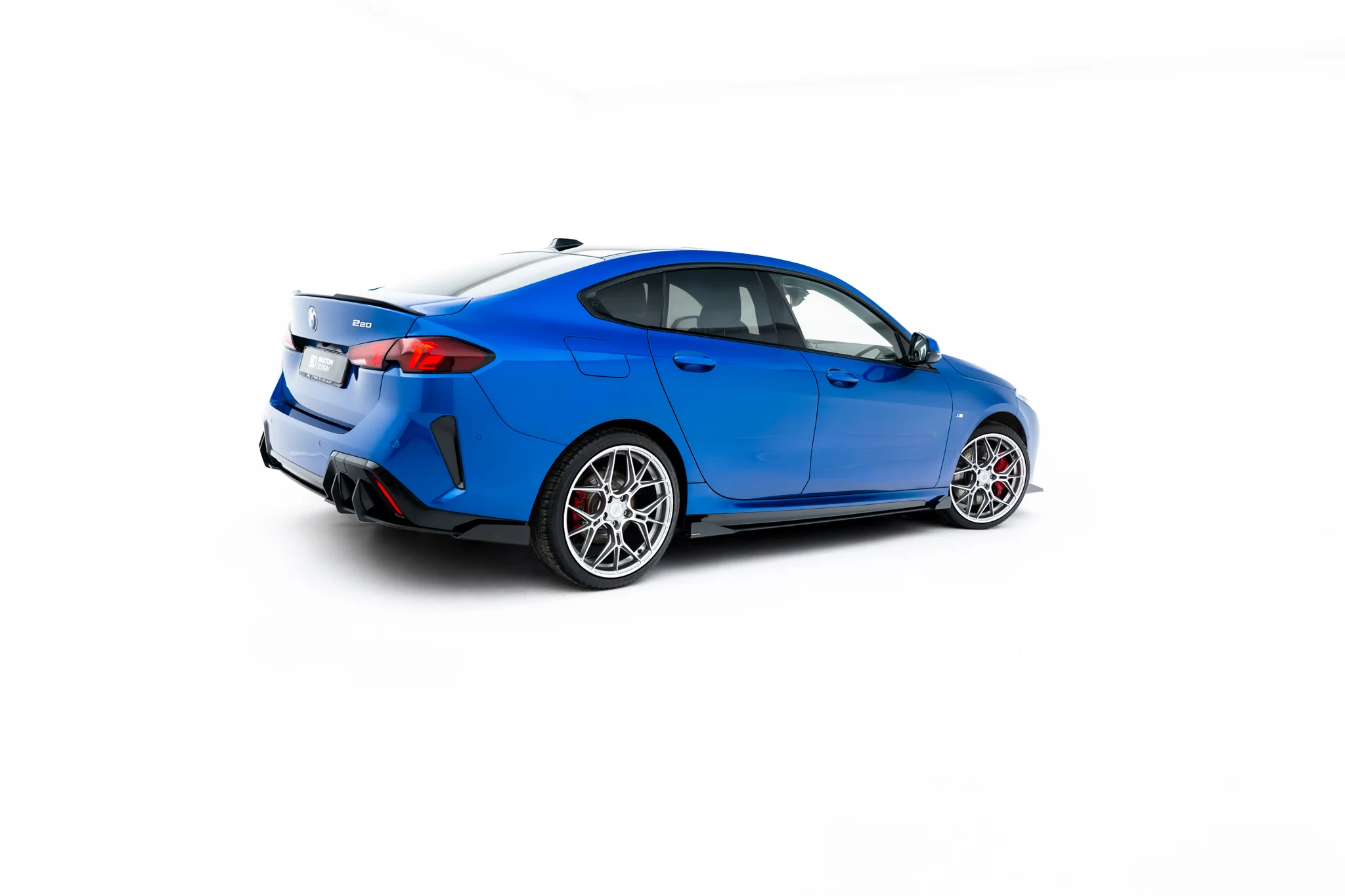 pol_po_Street-Pro-Side-Skirts-Diffusers-Flaps-BMW-2-M-Pack-M235i-Gran-Coupe-F74-23843_7webp - OPSHOLDERS Blue BMW two-door coupe shown from rear three-quarter angle with alloy wheels and red taillights
