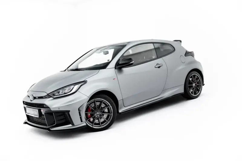 Front-left angled view of a grey GR sports car with large black wheels on a white background.