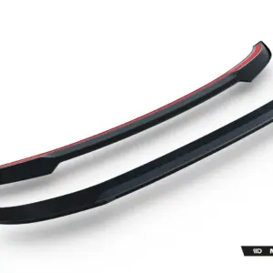 Black car side skirts with a red accent stripe, angled diagonally across the image (Maxton Design product).