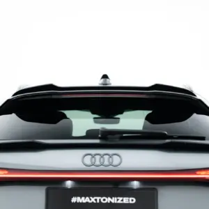 Rear view of a silver Audi with prominent logo, taillights, and a black plate area reading #MAXTONIZED