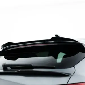 Rear view of a silver Audi with a spoiler and taillight on a white background.