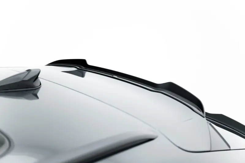 Close-up of a white car roof with a black spoiler and sleek lines omitted in background.