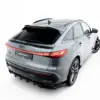 Rear three-quarter view of a silver Audi SUV with prominent taillights on a white studio background.