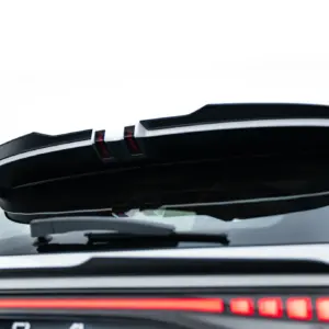 Rear view of a white hatchback with the tailgate raised, exposing the open cargo area and red taillights beneath a spoiler.