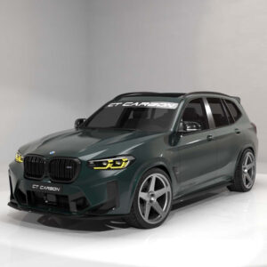 Green BMW SUV with carbon fiber front bumper and large silver wheels, photographed in a bright studio.