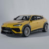06_1cfb5dd3-f1e2-4831-a81c-ed70082c98dcjpg - OPSHOLDERS Yellow high-performance SUV-style car with black cladding and oversized alloy wheels, shown in a studio setting, angled front-left view.