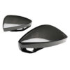 Carbon fiber bicycle helmet shells viewed from the side showing aerodynamic shape and internal mounting brackets