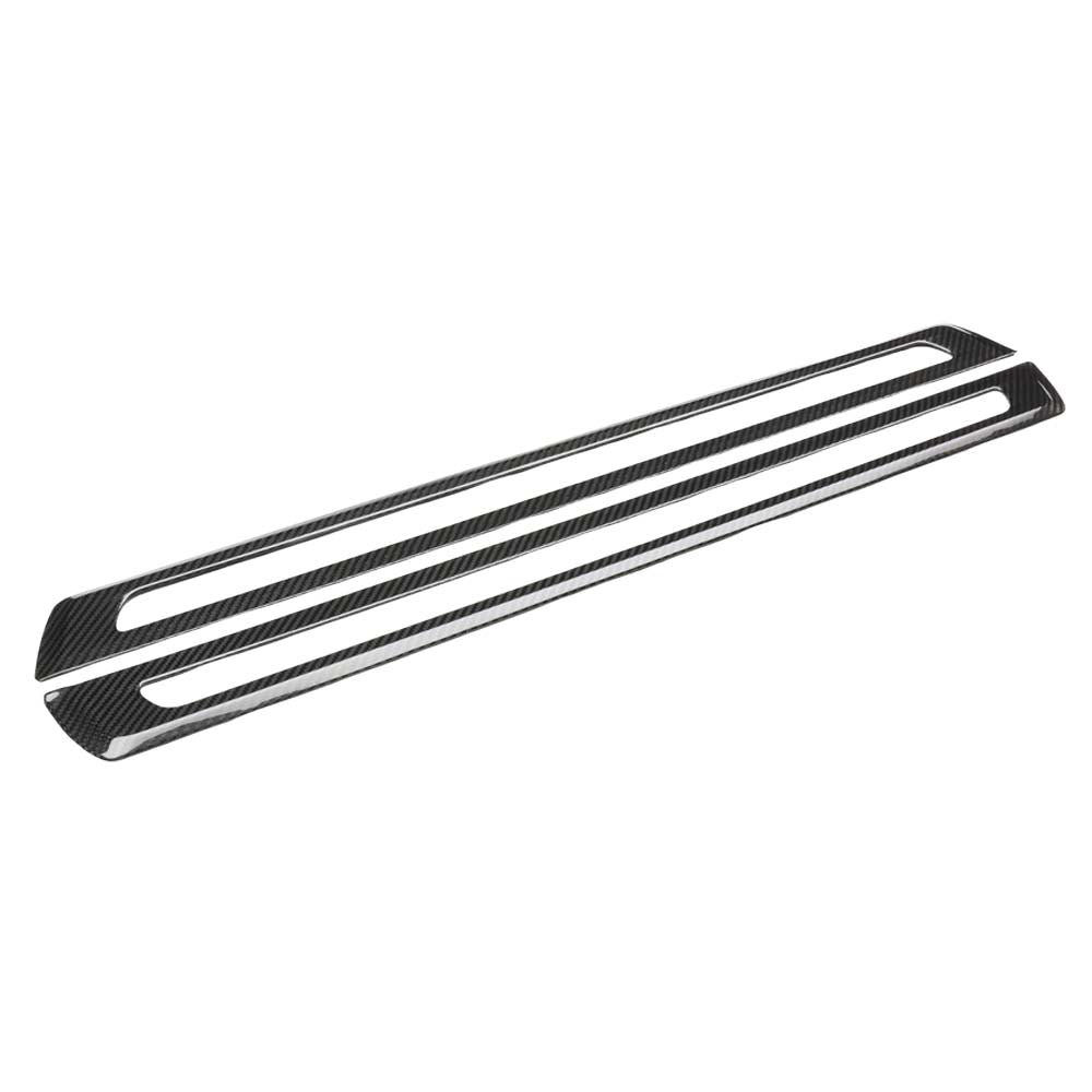 085A4680jpg - OPSHOLDERS Long carbon fiber trim piece with two parallel elongated slots along its length (decorative automotive accessory).