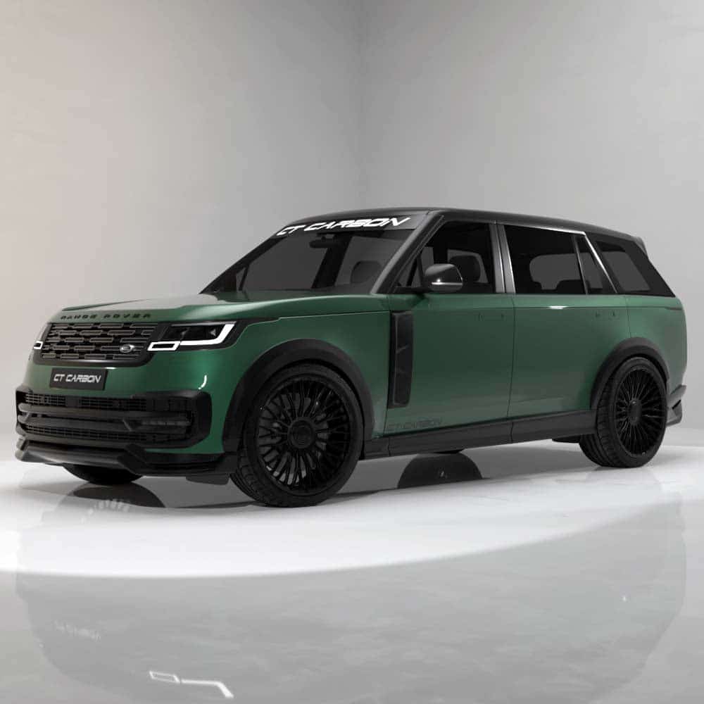 08_1f2d58a8-0a67-44c8-8479-b2106eed1e9bjpg - OPSHOLDERS Green Range Rover-style SUV with black roof and large black multi-spoke wheels, displayed in a studio setting.