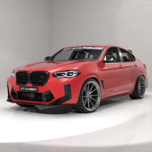 Red BMW sports sedan with widebody kit, large silver alloy wheels, and black kidney grilles in a white photography studio backdrop