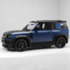 14_bb0f968a-6589-4ad3-92cc-66e05aa12a32jpg - OPSHOLDERS Blue and black two-tone off-road SUV seen from the side with large black wheels, in a white studio setting.