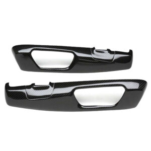 Pair of glossy black carbon fiber interior door-handle trim pieces for a car.