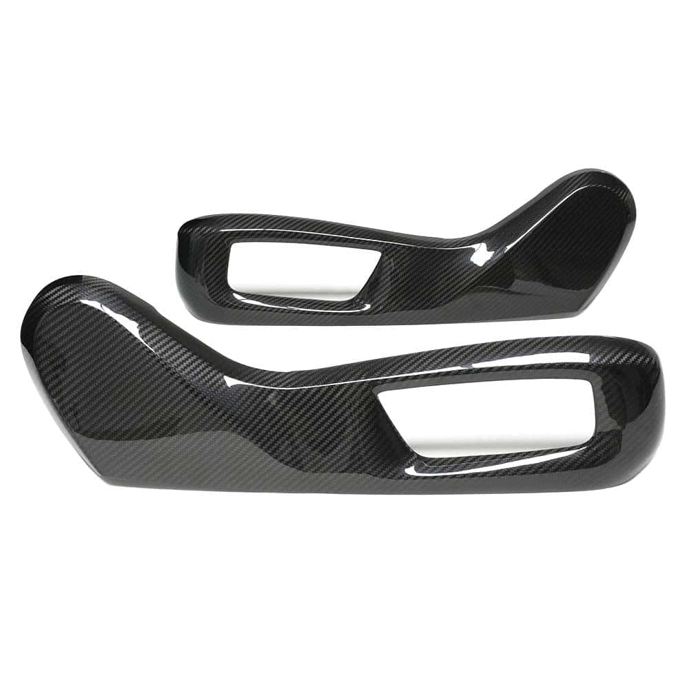 1_0a2e17a4-438c-4bc1-9961-0dfdee8d9dd0jpg - OPSHOLDERS Two glossy carbon fiber automotive interior trim pieces with rectangular openings.