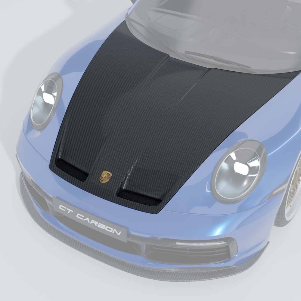 22_08422213-a237-4d25-9f3c-da689fca41b1jpg - OPSHOLDERS Front view of a blue sports car with a large carbon fiber hood and Porsche emblem, sport bumper and carbon lip spoiler (CT CARBON).