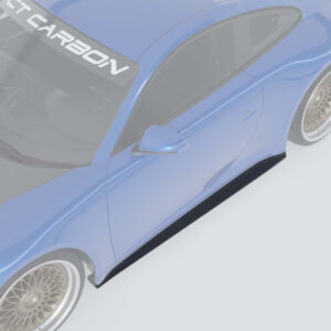 Blue sports car viewed from above, highlighting a carbon fiber side skirt, side mirror, and gold-rimmed wheel; windshield shows the word CARBON.