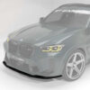 24_3d537f97-b232-45e3-9d10-aba31640391ejpg - OPSHOLDERS 3/4 front view of a gray BMW SUV with a carbon fiber front splitter and CT Carbon branding on the windshield area.