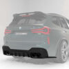 28_7f0d40b5-39d0-4bc5-9ca9-1039baed03d7jpg - OPSHOLDERS Rear view of a green BMW SUV with 'CT CARBON' badge and quad exhausts, highlighting sporty diffuser and taillights