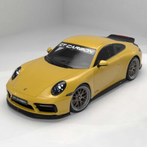 Yellow Porsche 911 in a bright studio with a front lip spoiler and 'ST CARBON' banner across the windshield