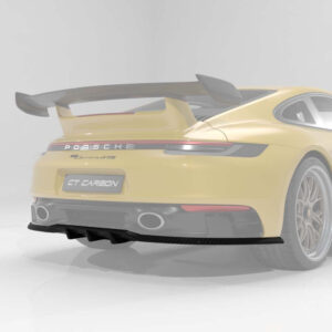 Rear view of a yellow Porsche 911 GT3 RS with a large rear wing and diffuser in a studio setting