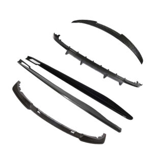 Set of carbon fiber car body kit parts laid out, including front splitter and side skirts pieces for an aerodynamic kit
